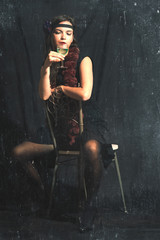 Vintage style photograph with created artifacts of a 30s style woman with alcohol