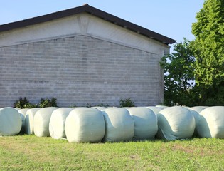 Obraz premium hay bales coating with plastic film for protection from the overtime