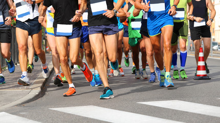 Fototapeta na wymiar runners run at finish line during race in the city
