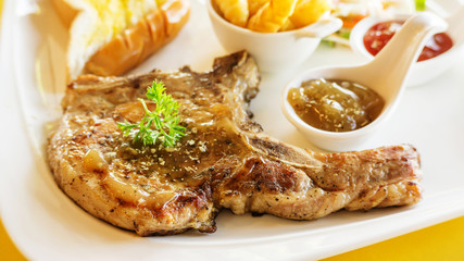 Pork Chop steak on a yellow table.