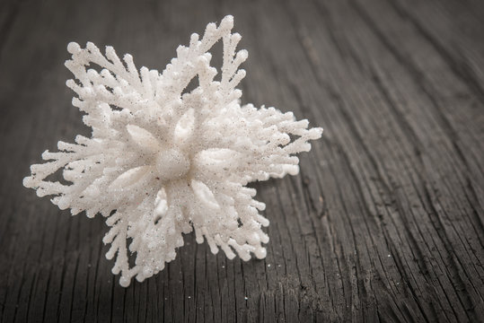 Closeup of snowflake on vintage wood