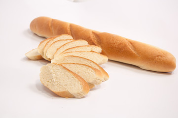 Fresh baguette, sliced, isolated on white background