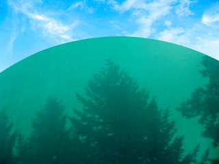 green blue background, green balloon tent for tennis and mini football  and shadows of trees