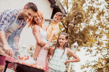 Family having a lunch in their garden in summer.