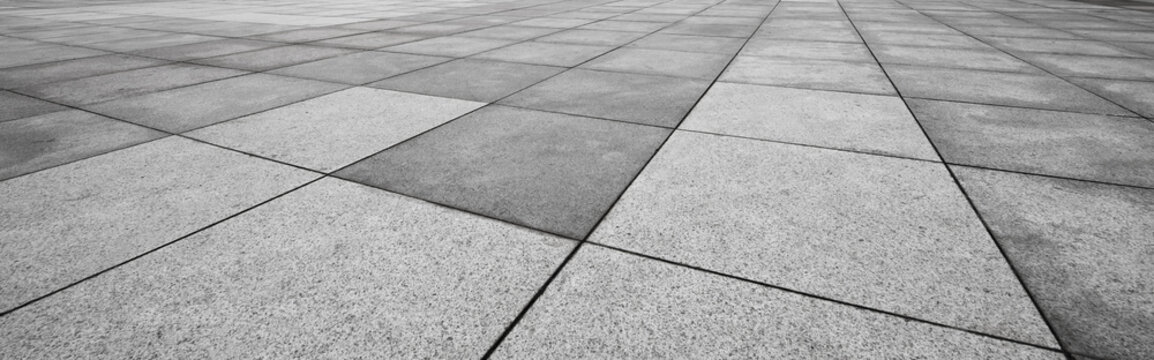 Perspective View Of Monotone Gray Brick Stone On The Ground For Street Road. Sidewalk, Driveway, Pavers, Pavement In Vintage Design Flooring Square Pattern Texture Background