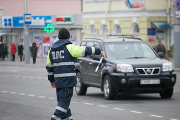 GOMEL, BELARUS - December 18, 2017: Officer of the road patrol service with a baton..