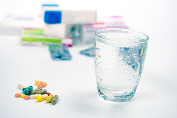 Tablets and medicines and a glass of water