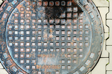 Metal drain cover on the pavement