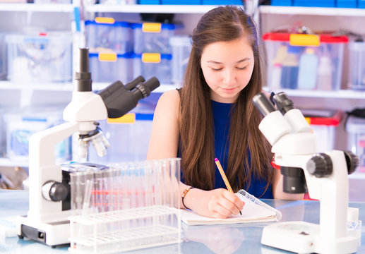 A teenage girl in a school laboratory in chemistry and biology classes