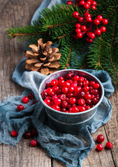 Red cranberries on a old wooden table