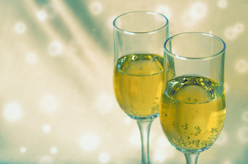 two glasses of champagne on a background of a fabric. toned.