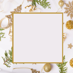Christmas holiday composition. Festive creative golden pattern, xmas gold decor holiday ball with ribbon, snowflakes, christmas tree on white background.