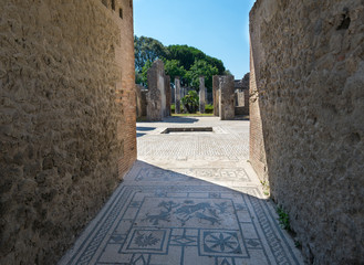 Walking around the ruins and the empty streets of the ancient antique site of Pompeii destroyed by...