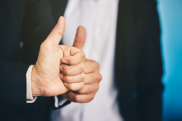 Businessman is lifting thumbs To display indescribably and agree to terms in business.