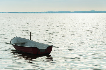 Alone boat on Denmark fyord on sea with cloudy sky