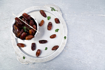 Dry fruit dates on silver tray. Copy space. Top view.