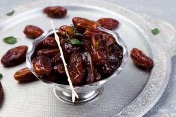 Dry fruit dates on silver tray. Copy space.