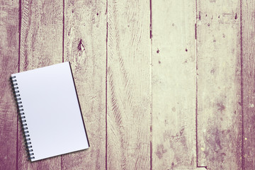 Blank notebook on brown wooden background