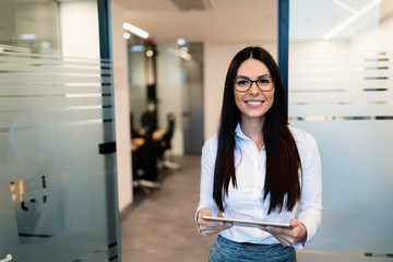 Portrait of successful businesswoman holding digital tablet