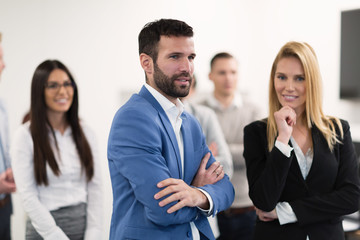 Successful team of young perspective businesspeople in office