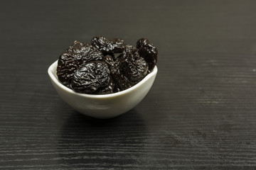 A bowl with dried plums.