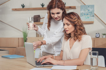Obraz na płótnie Canvas young businesswoman working with laptop together
