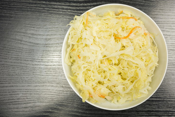 Top view of a white bowl with sauerkraut.