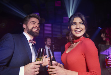 Cheerful couple spending time together at night club