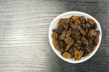 Fototapeta premium A bowl of raisins. View from above.