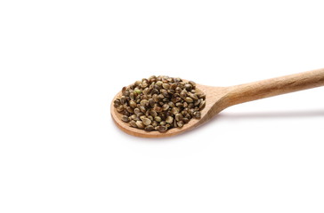Hemp seeds in wooden spoon isolated on white background