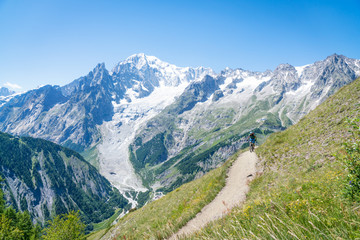 A mountain biker riding on an alpine trail in the Aosta Valley, Italy.