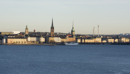 Fototapeta na wymiar Stockholm waterfront at lake Malaren. Landmarks on Riddarholmen, The Knights' Islet, and the old town, in midwinter pale sunlight