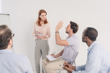 Fototapeta premium cropped shot of middle aged multiethnic people talking together during anonymous group therapy