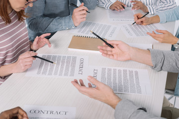 cropped shot of middle aged people working with papers together