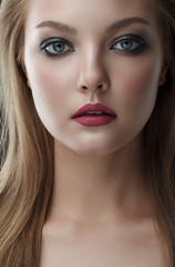 Closeup beauty portrait of young beautiful woman blond girl with long straight hair with natural makeup. Hairstyle and skincare and cosmetics concept