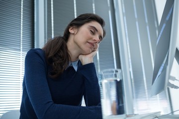 Fototapeta premium Female executive relaxing at desk