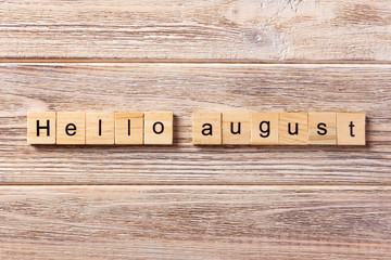 hello august word written on wood block. hello august text on table, concept