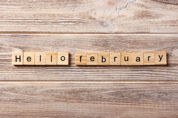 Hello February word written on wood block. Hello February text on table, concept