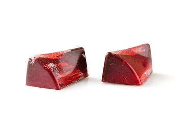 Red colored handmade chocolate candies on white background