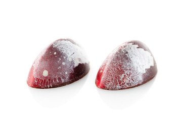 Red colored handmade chocolate candies on white background