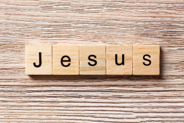 Jesus word written on wood block. Jesus text on table, concept