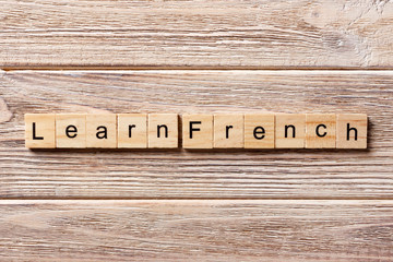 learn french word written on wood block. learn french text on table, concept