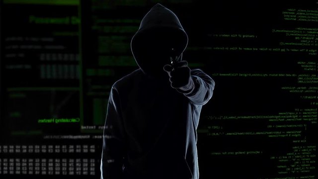 Hacker silhouette holding gun, destroying security camera, threat and crime