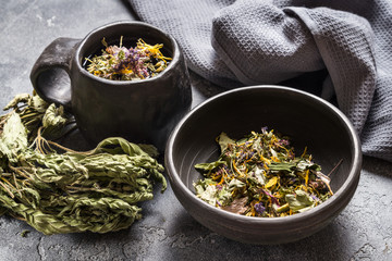 Herb tea in black ceramic table ware