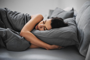 GIrl lying down in bed and sleeping