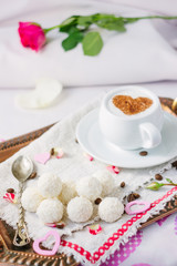 Candy and coffee on bed.