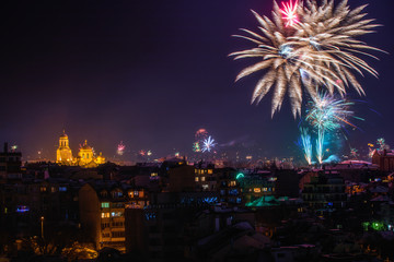 Downtown Varna cityscape with many flashing fireworks celebrating New Year's Eve