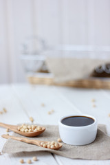 Obraz na płótnie Canvas soybean sauce in a white ceramic bowl on piece of cloth