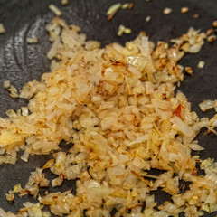 fried onions in a pan closeup