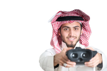 Young muslim guy trying VR glasses. Isolated.